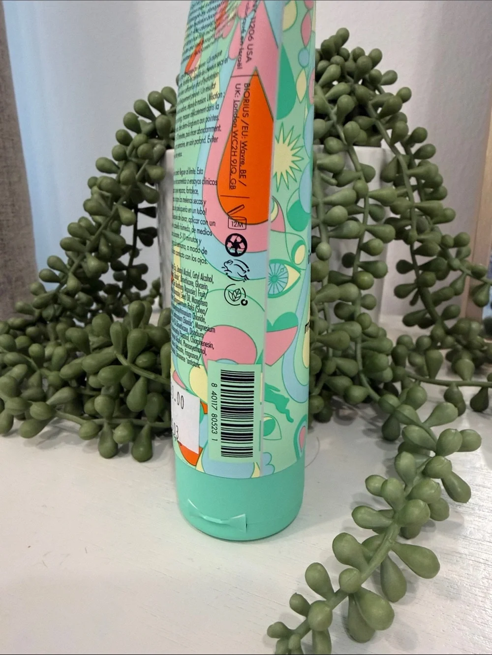 amika Mint Green Bond Repair Hair Mask with Colorful Floral Graphic